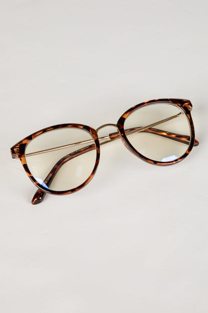 Tortoiseshell cat-eye glasses on a light gray background