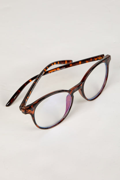 Tortoiseshell eyeglasses on a light gray background