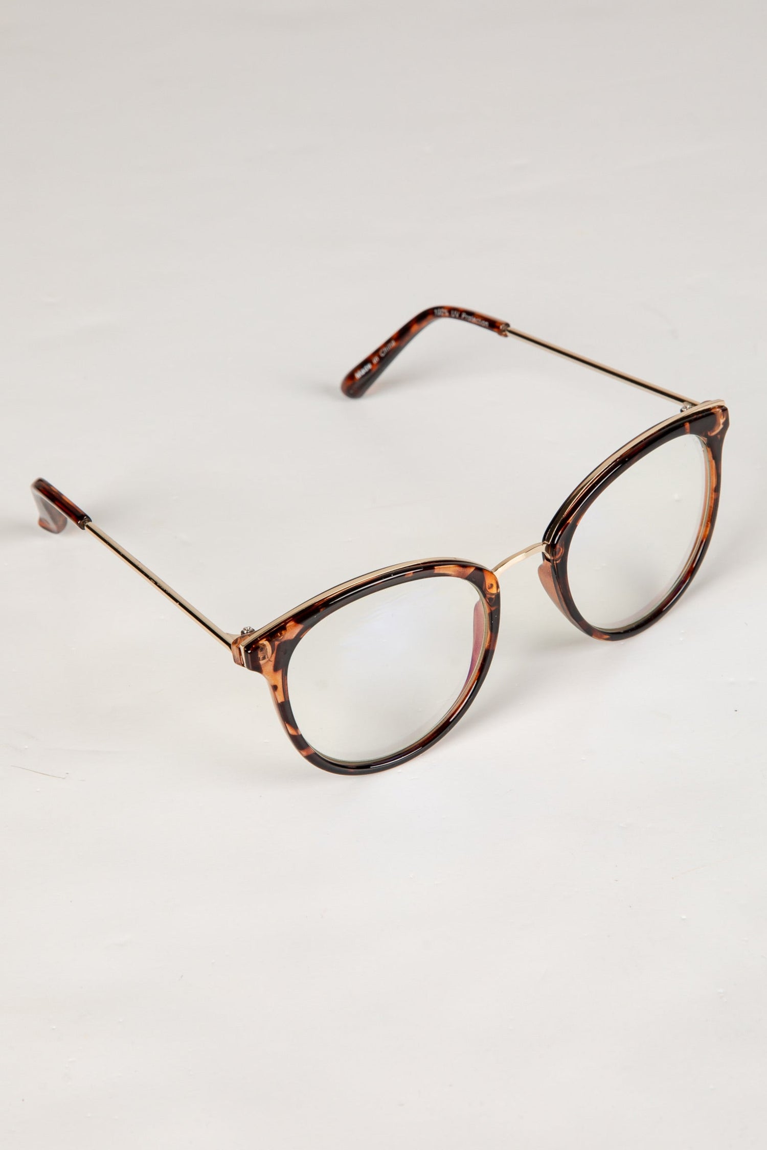 Tortoiseshell eyeglasses on a light gray background