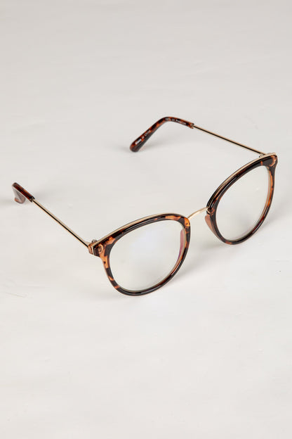 Tortoiseshell eyeglasses on a light gray background