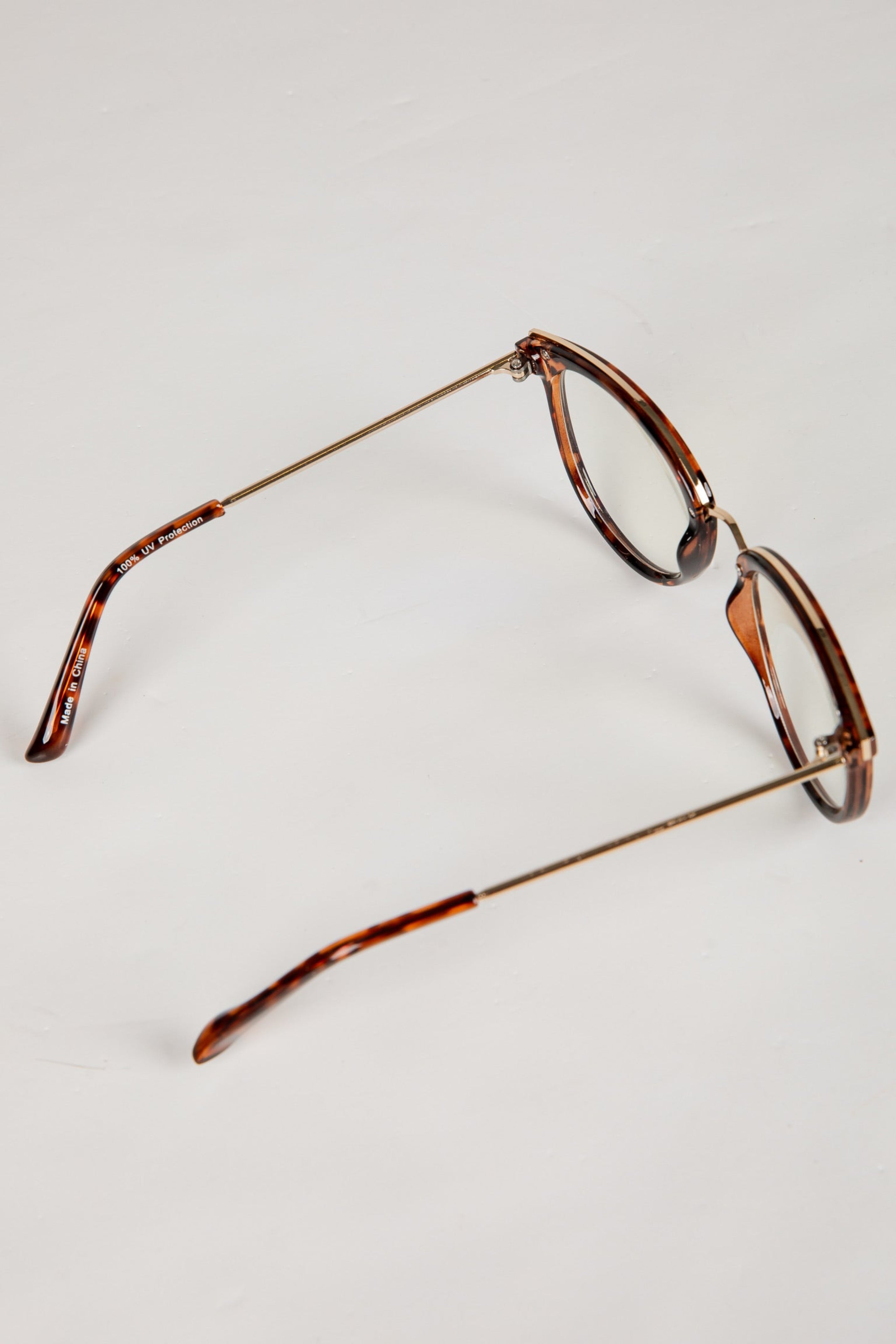 Tortoiseshell eyeglasses on a light gray background
