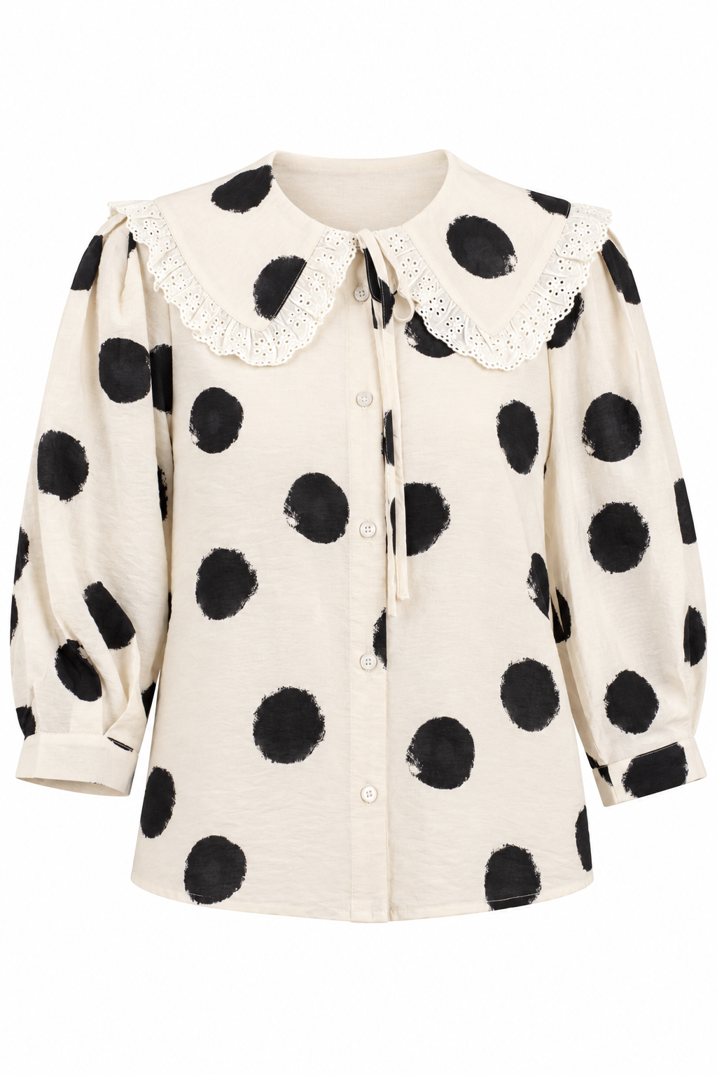 An off-white long-sleeve blouse with black polka dots, featuring a lace-trimmed Peter Pan collar and a front button closure.