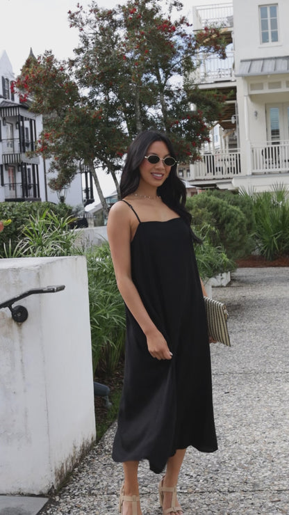 women in black midi dress