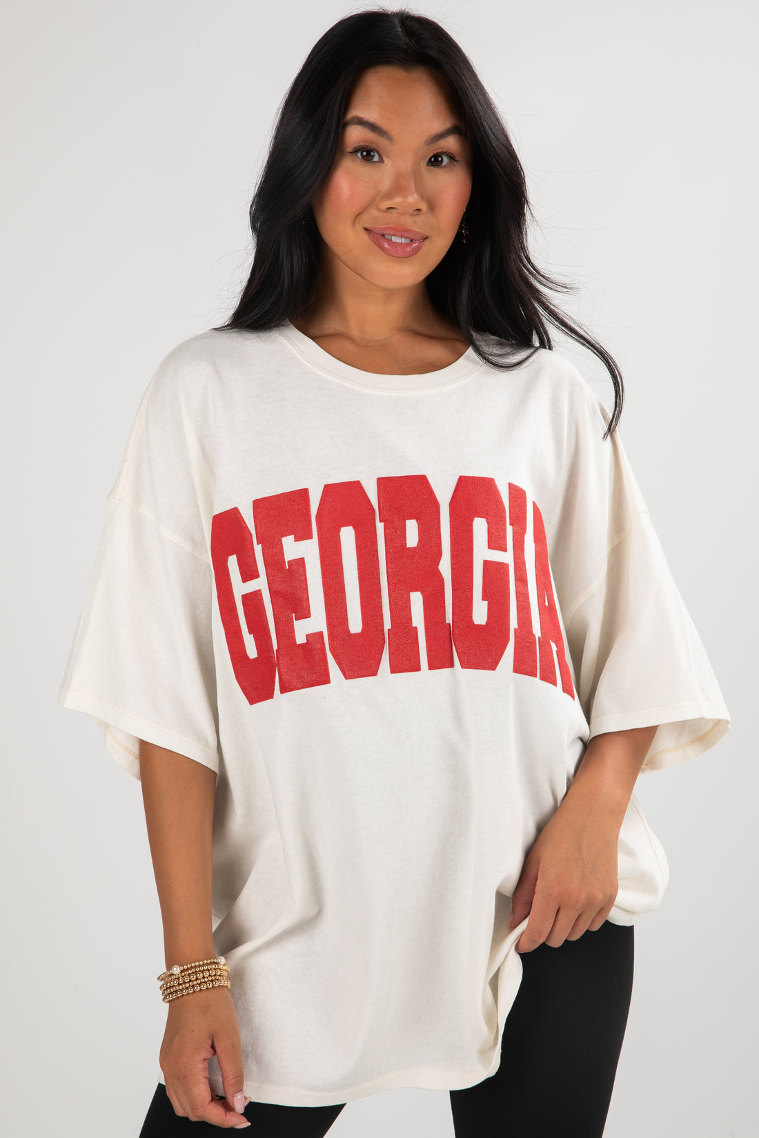 Woman wearing a white oversized t-shirt with &