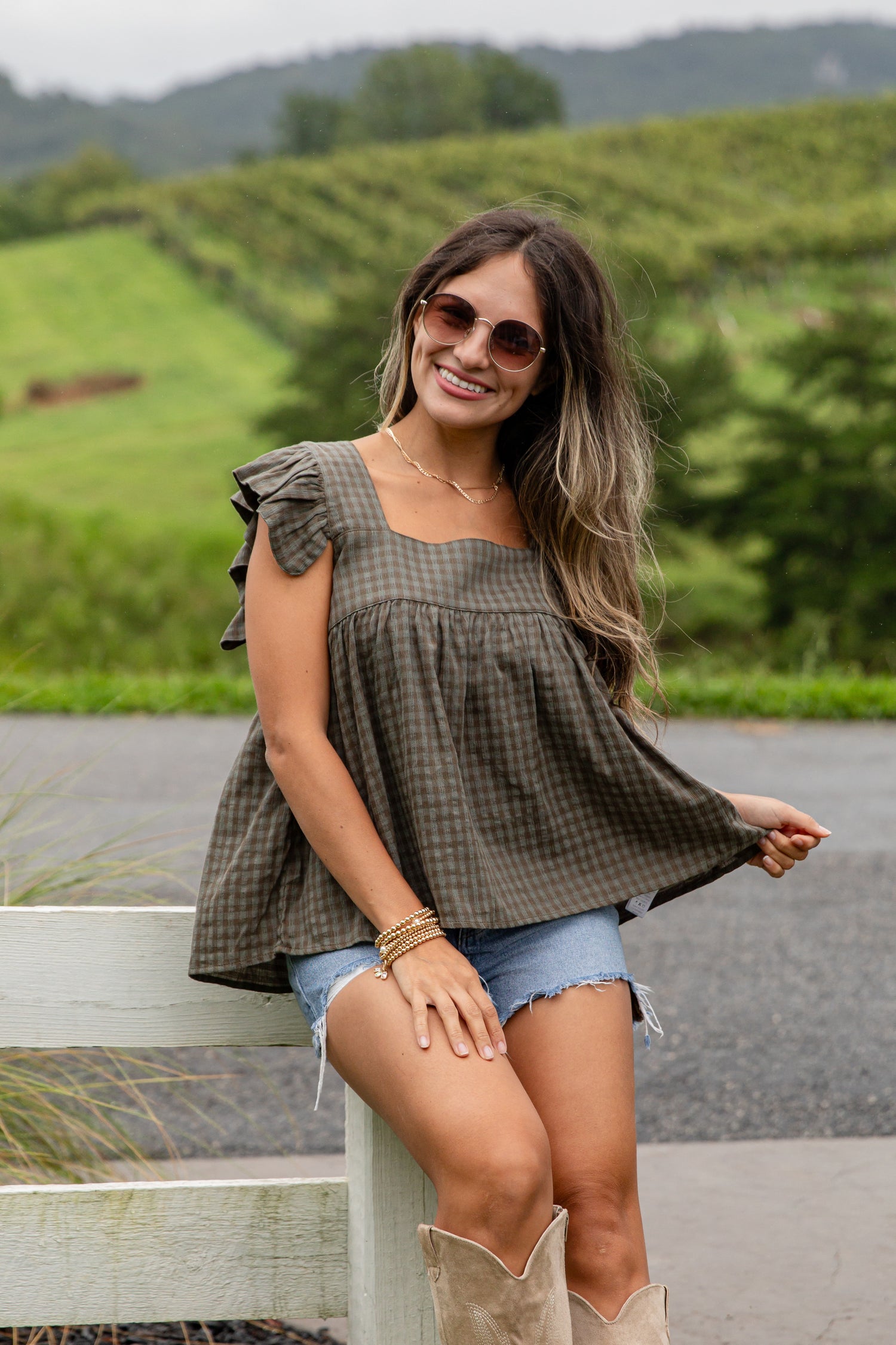 Woman sitting outdoors with a scenic background