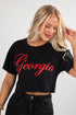 Woman wearing a black crop top with &
