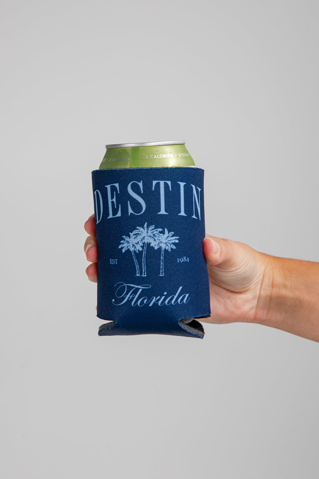 Hand holding a can with a &