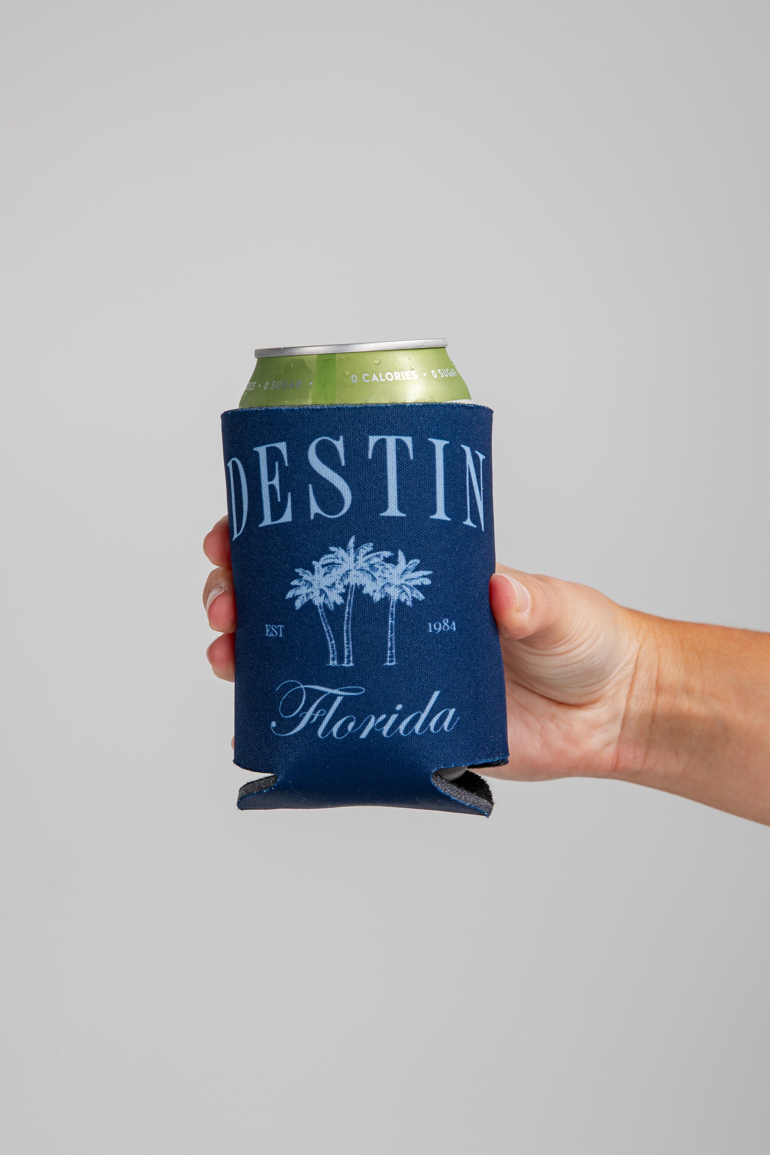 Hand holding a can with a &