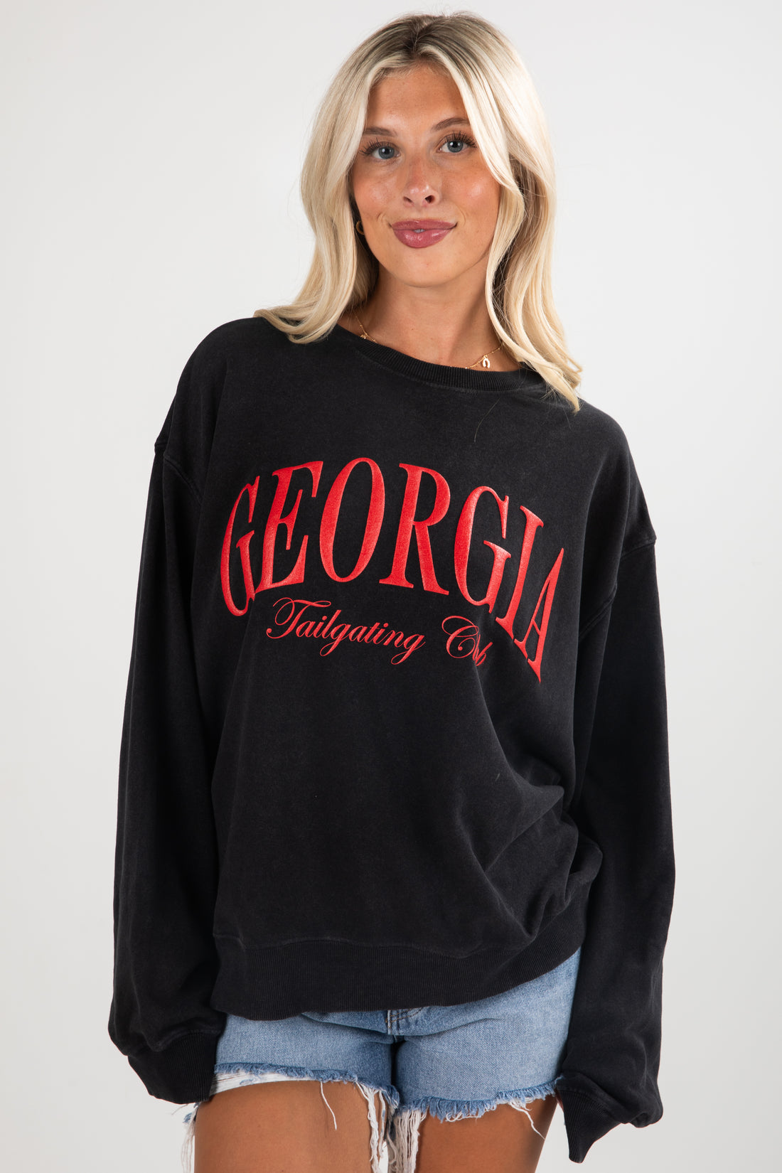 Woman wearing a black sweatshirt with &