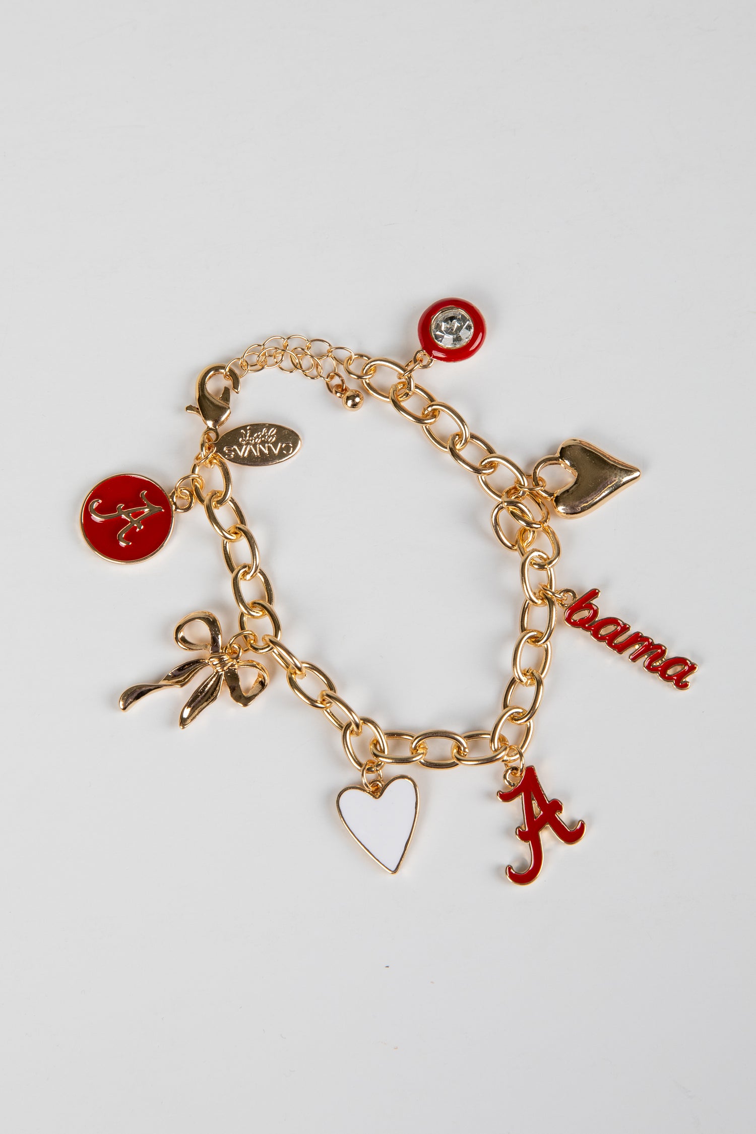 Gold charm bracelet with various charms on a white background
