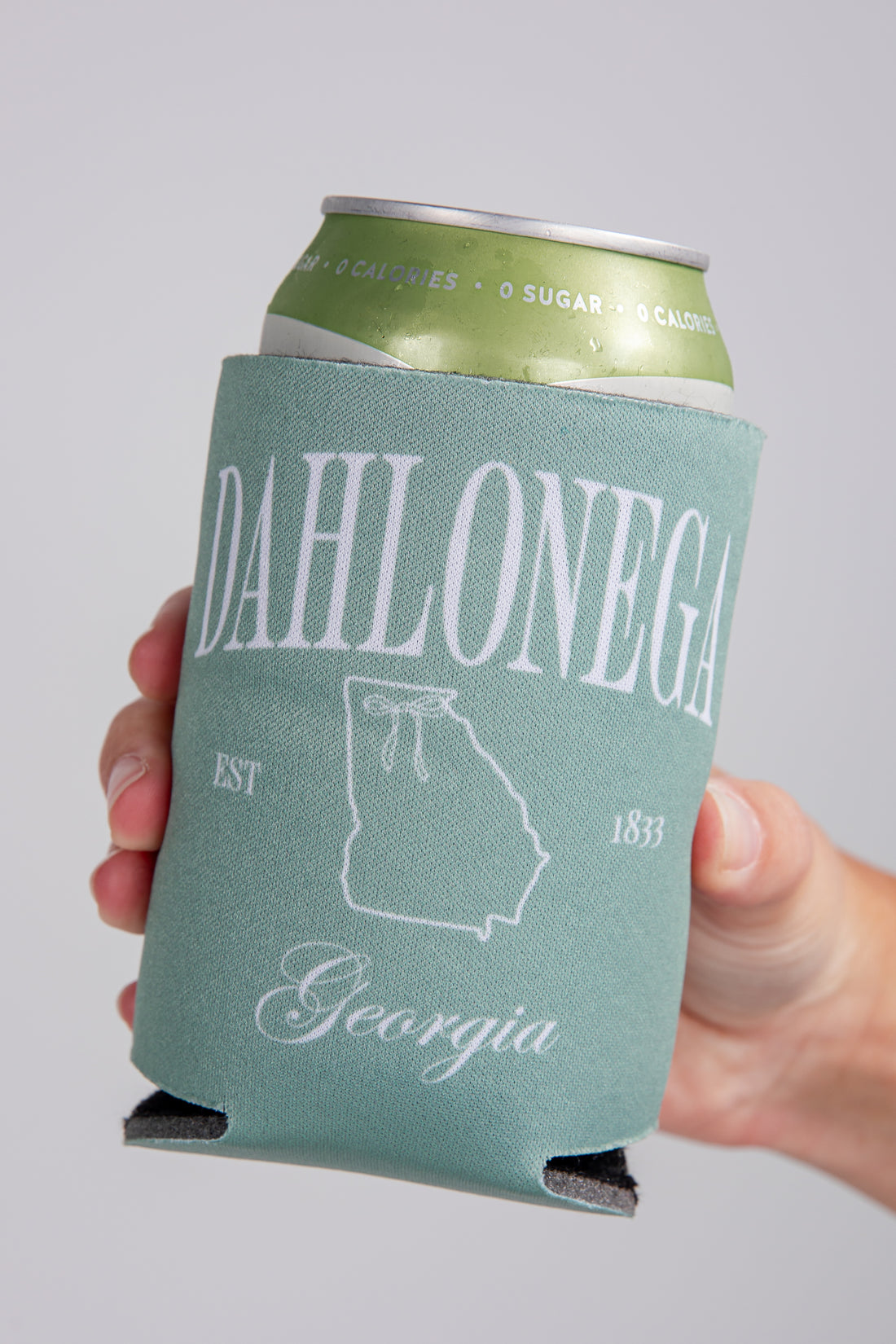 Can with a green sleeve featuring &