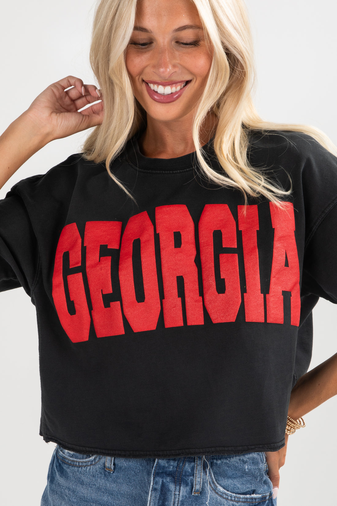 Person wearing a black sweatshirt with &