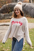 Woman wearing a beige sweater with &