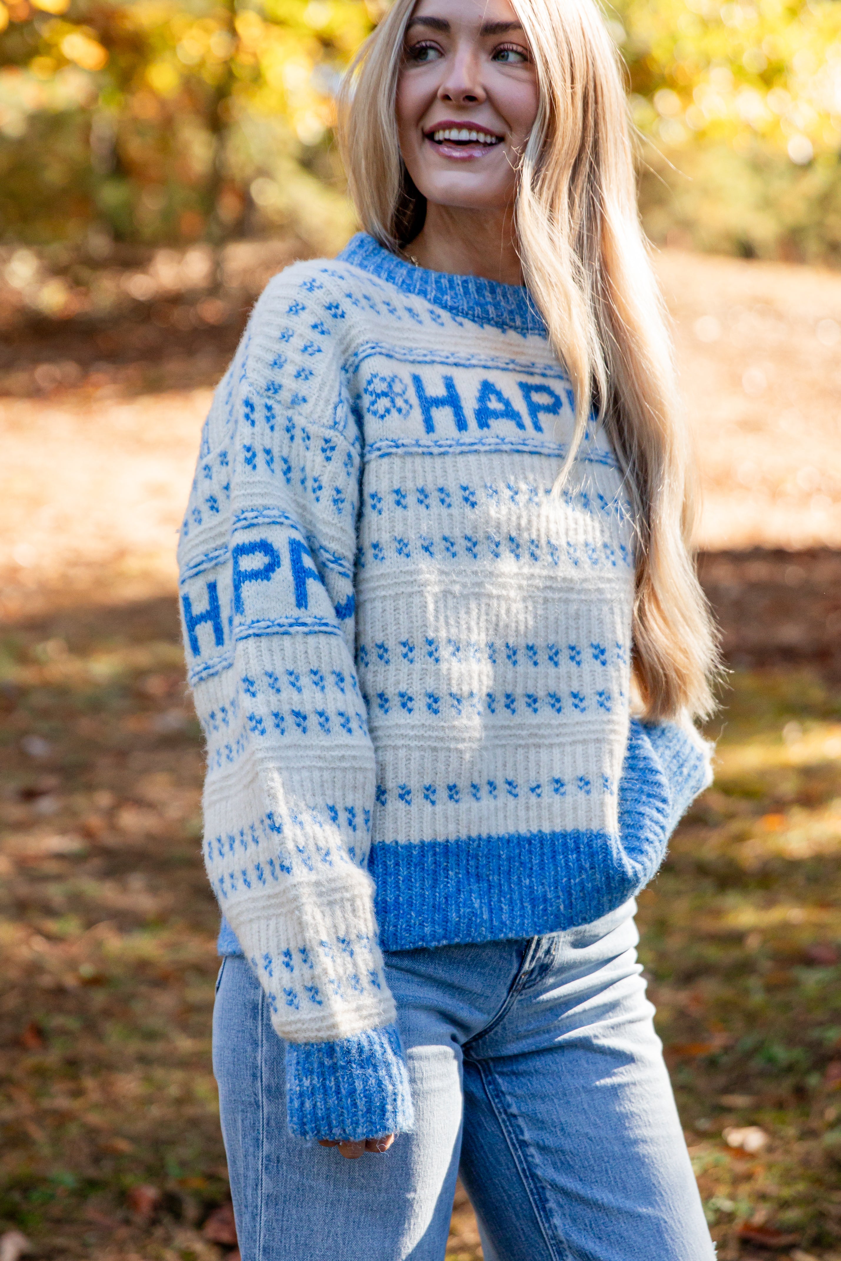 Person wearing a blue and white patterned sweater with &