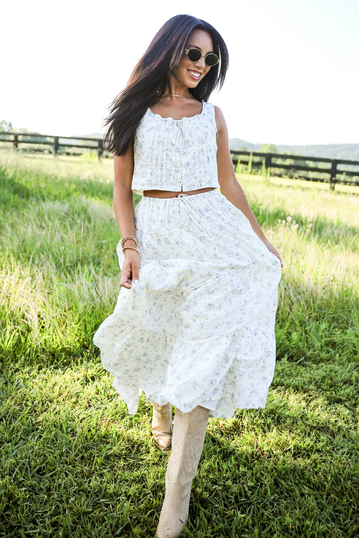 Woman in a white dress standing in a grassy field