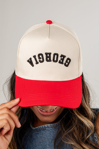 Person wearing a cap with &