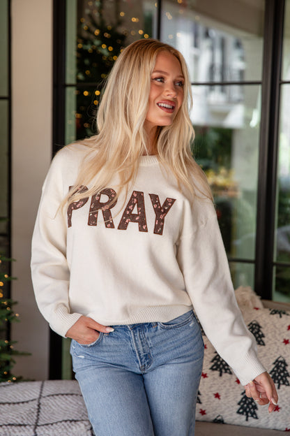 Woman wearing a white sweatshirt with &