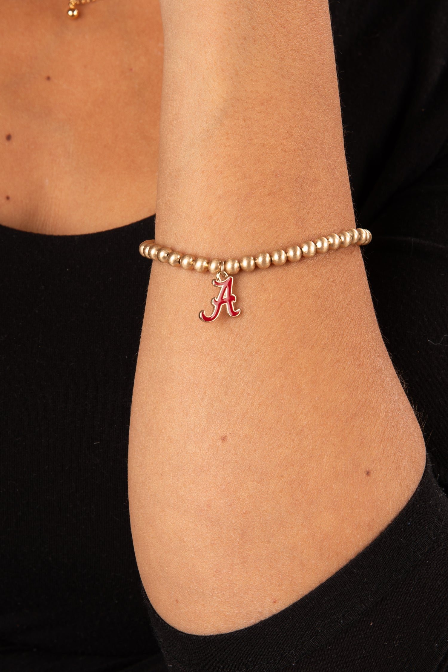 Gold bracelet with a red &