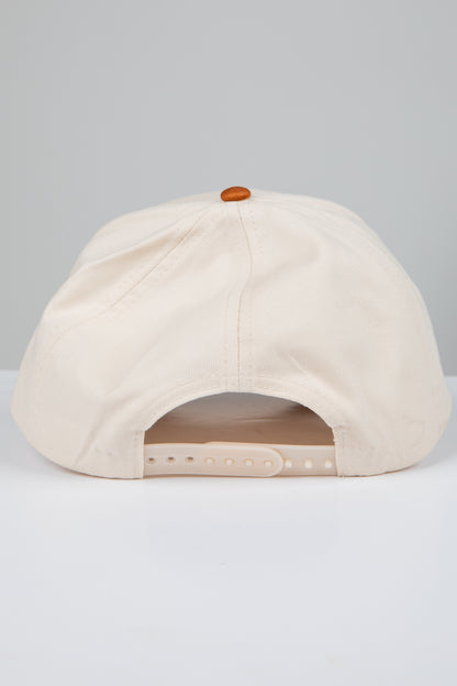 Beige cap with a brown button on a light gray background
