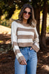 Woman wearing a striped sweater and sunglasses outdoors