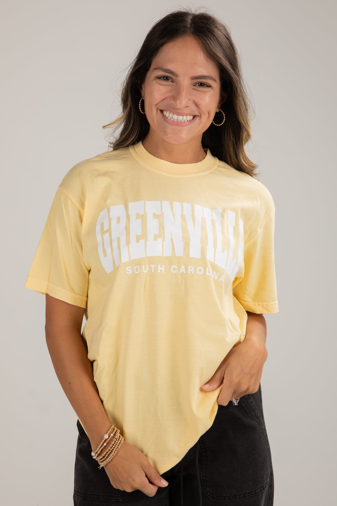 Woman wearing a yellow t-shirt with &