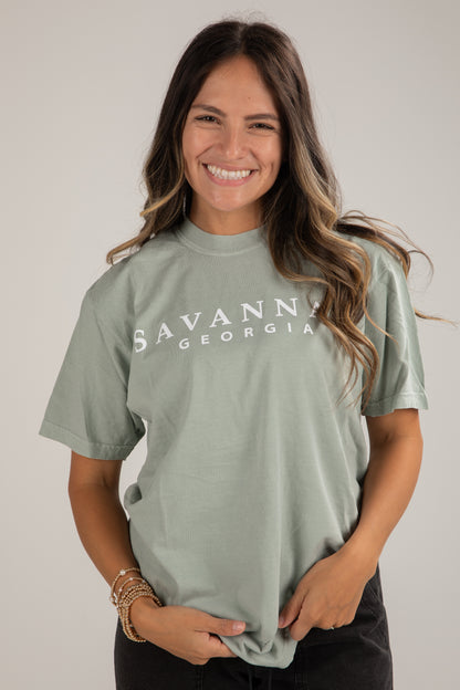 Woman wearing a green t-shirt with &