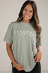 Woman wearing a green t-shirt with &