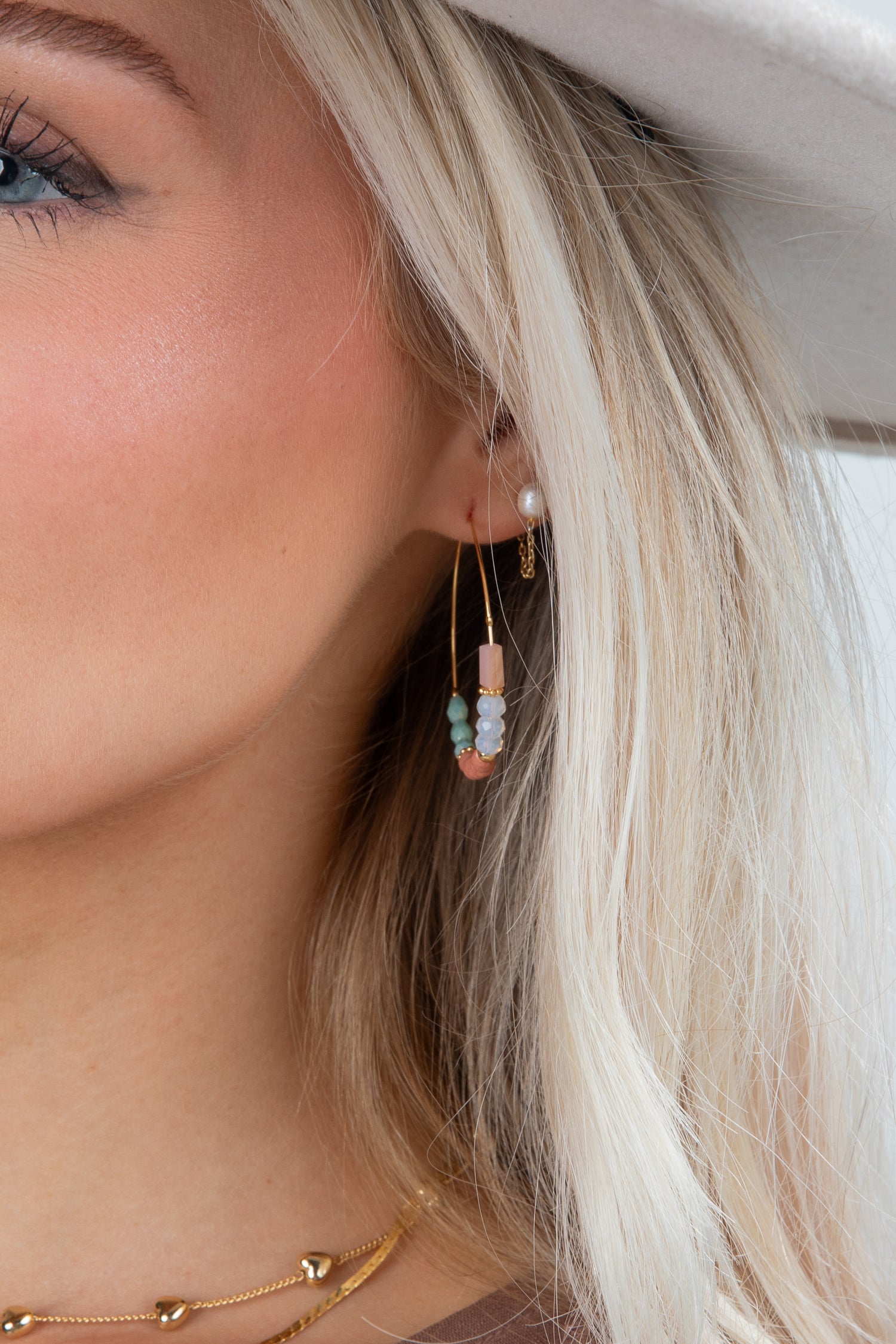 Close-up of a person wearing a beaded earring with a blurred background
