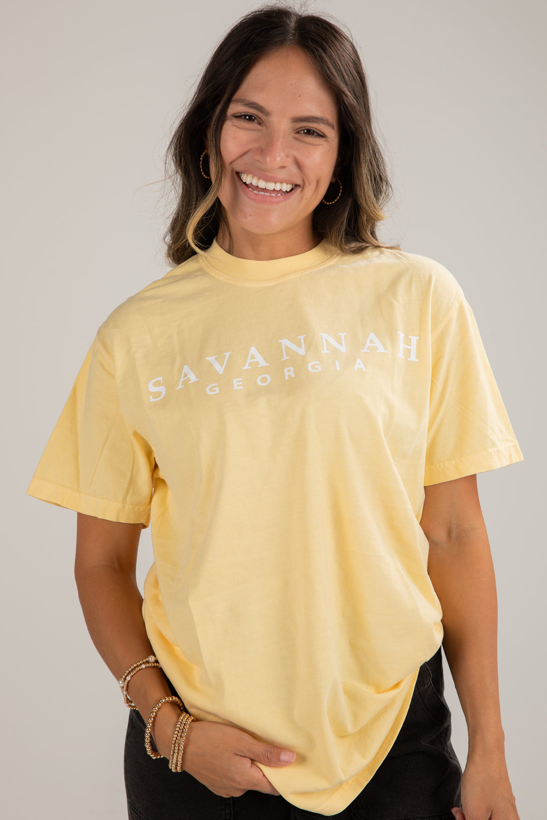 Woman wearing a yellow t-shirt with &