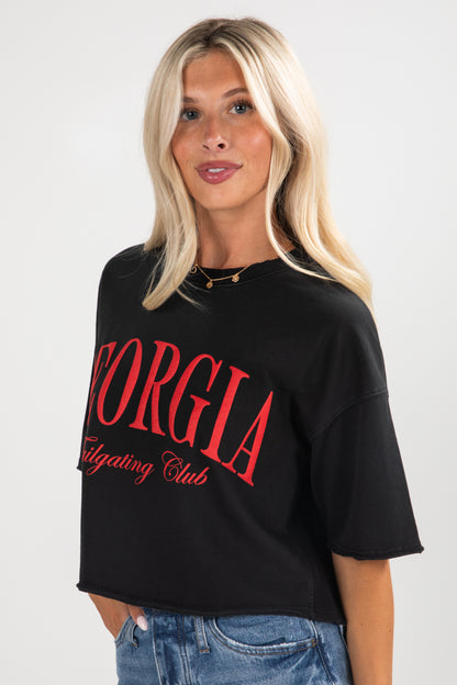 Person wearing a black t-shirt with red text on a white background