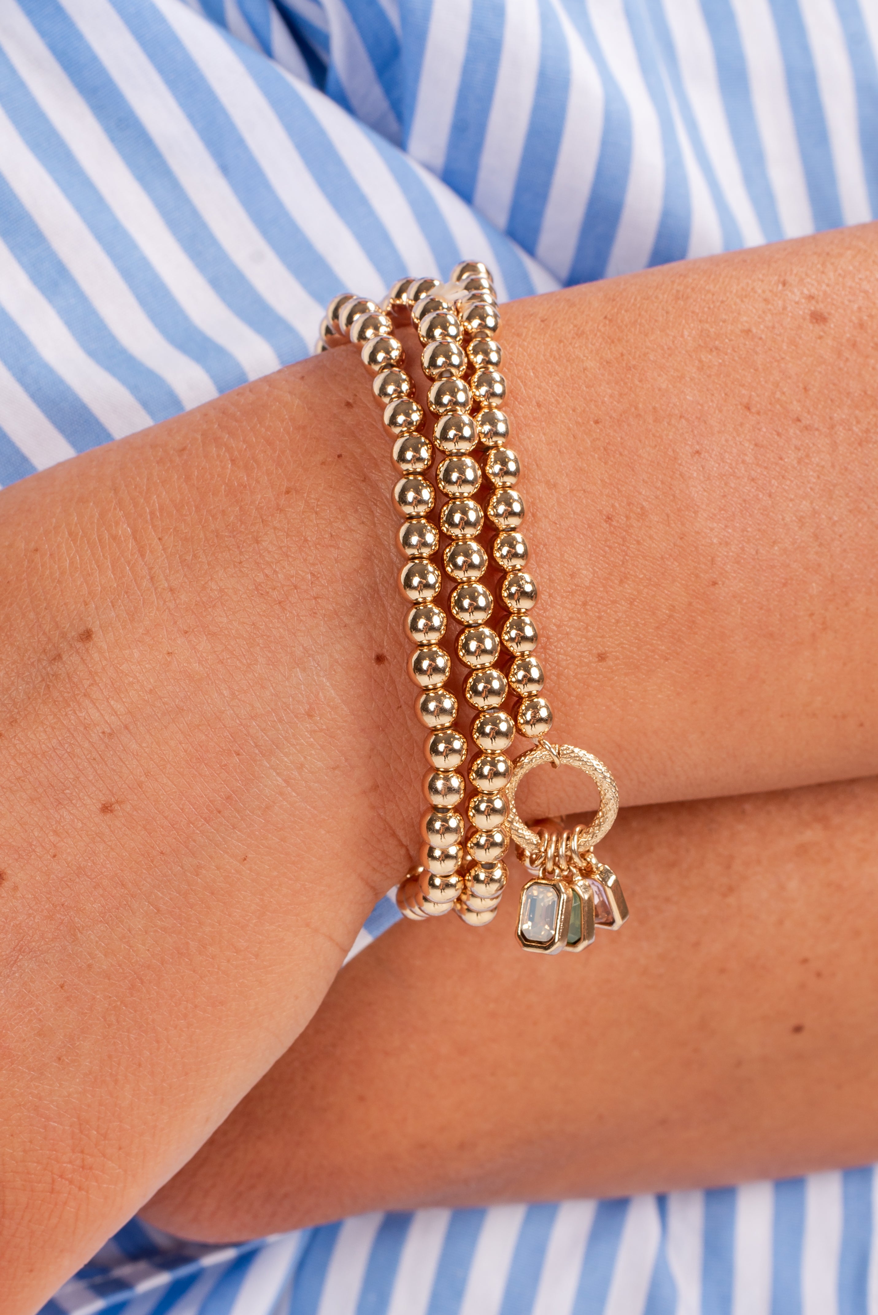 Gold bracelets on a person&