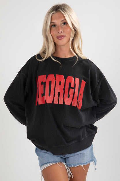 Person wearing a black sweatshirt with &