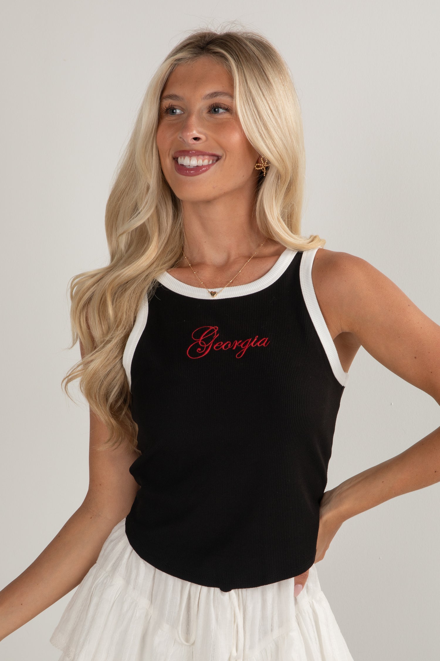 Woman wearing a black tank top with &