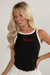 Woman wearing a black tank top with &