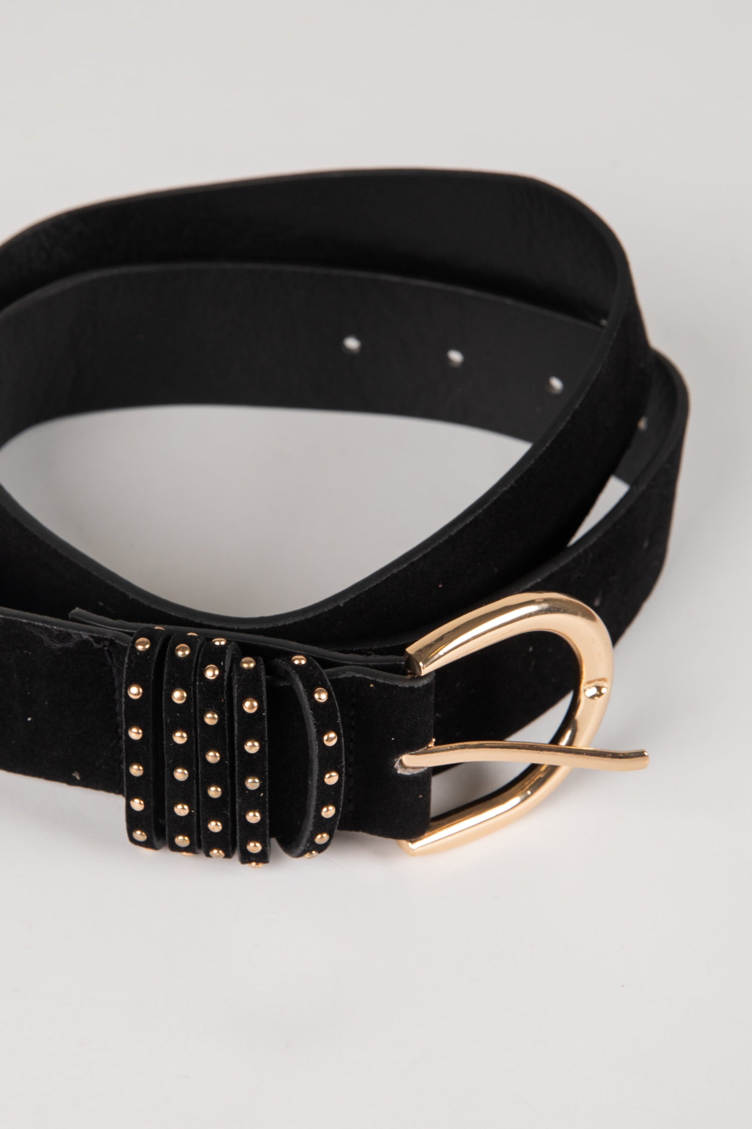 Black belt with gold studs and buckle on a light gray background