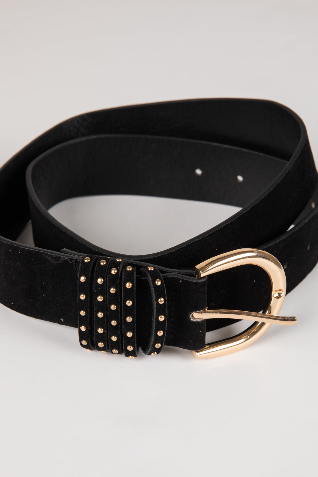 Black belt with gold studded detailing and buckle on a light gray background
