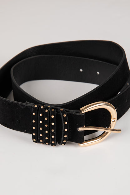 Black belt with gold studded detailing and buckle on a light gray background