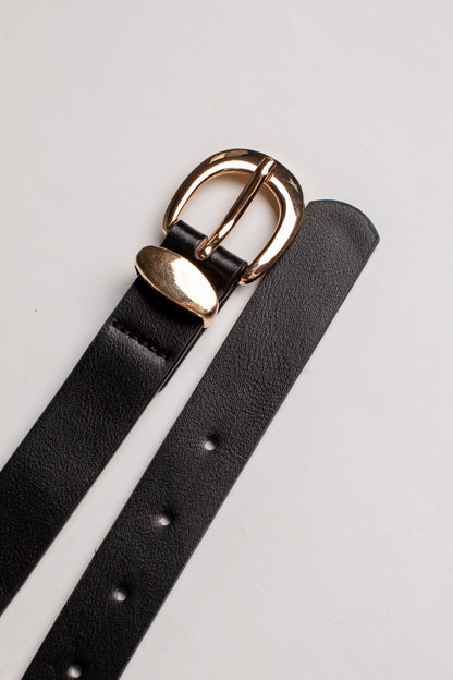 A close-up of a black leather belt strap with a polished gold-tone metal buckle, laid diagonally on a light gray background.
