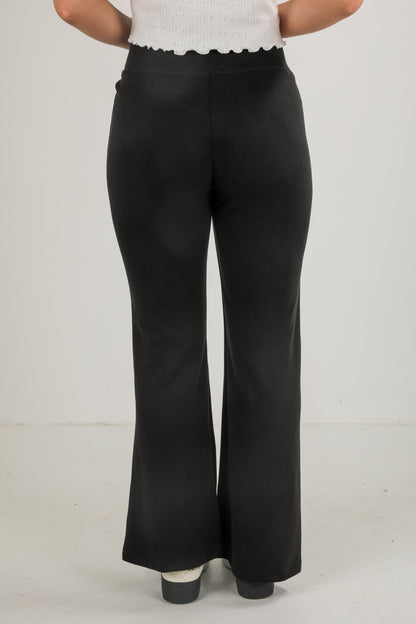 Black wide-leg pants worn by a person on a plain background