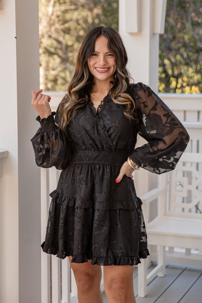 Woman wearing a black lace dress on a porch