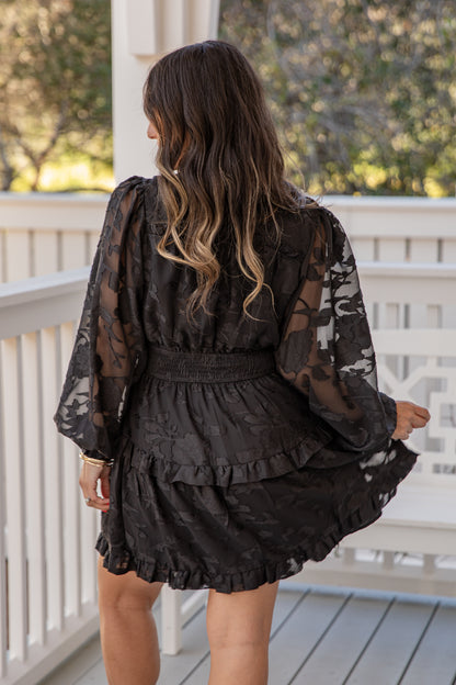 Woman wearing a black lace dress on a porch