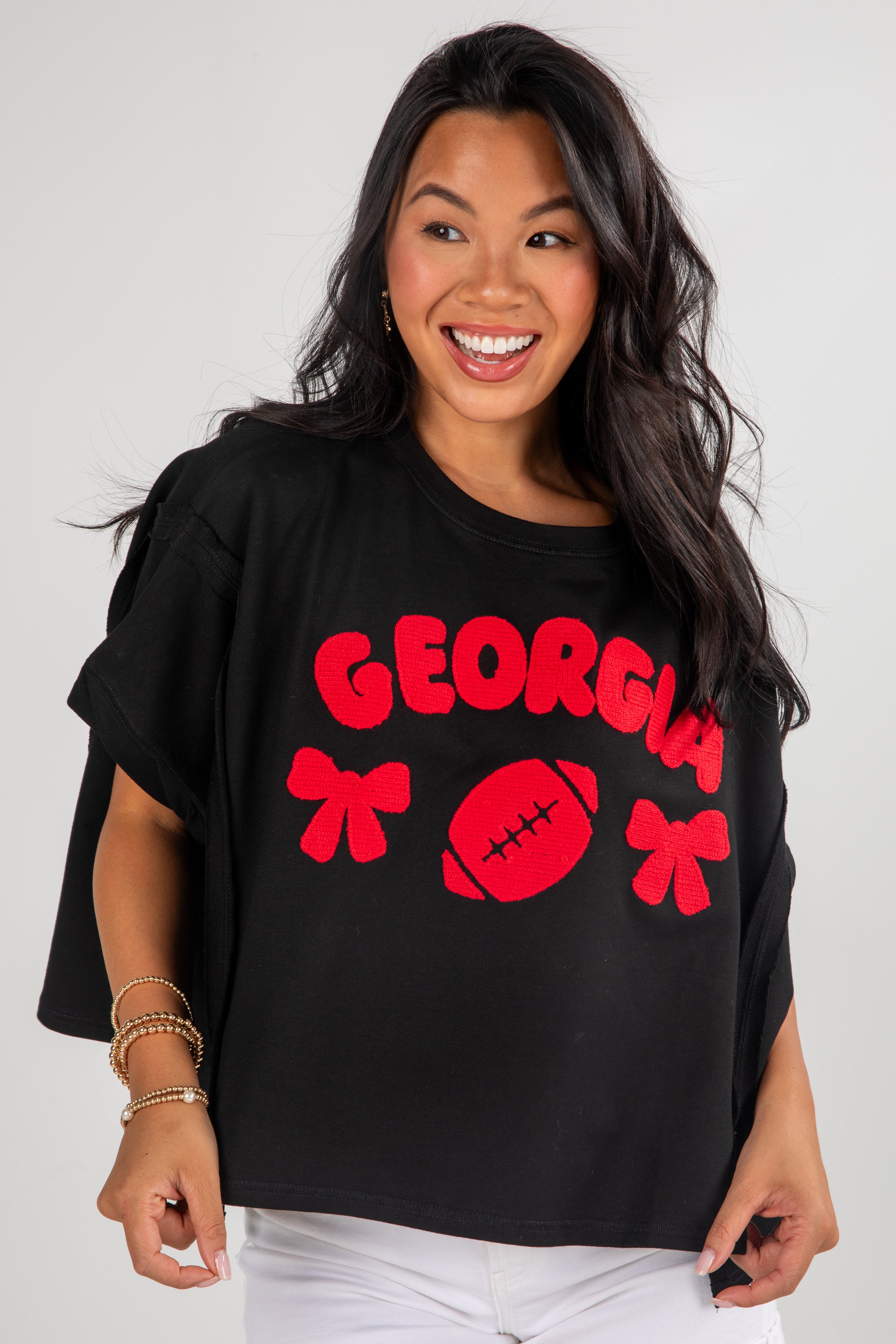 Woman wearing a black t-shirt with red &