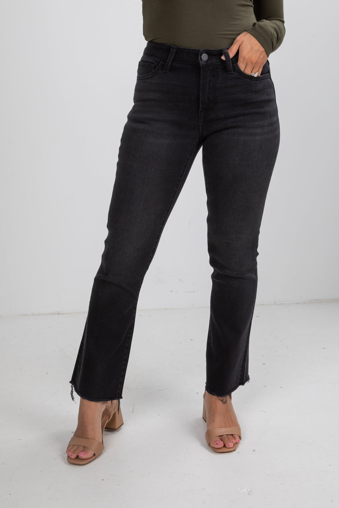 Person wearing black jeans on a white background