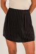 Black pinstripe skirt worn by a person on a plain background