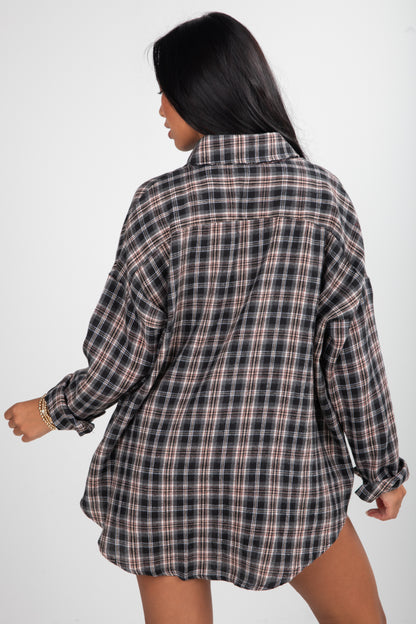 Person wearing a plaid shirt on a white background