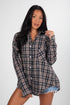 Woman wearing a plaid shirt against a white background