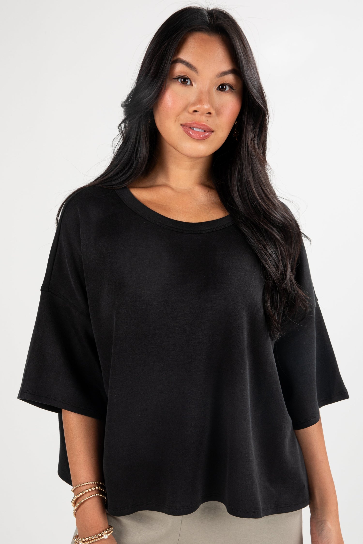 Woman wearing a black top against a white background
