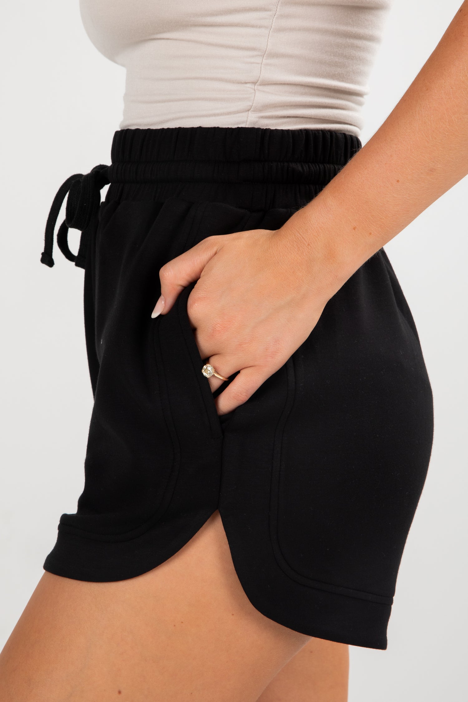 Black shorts worn by a person on a white background