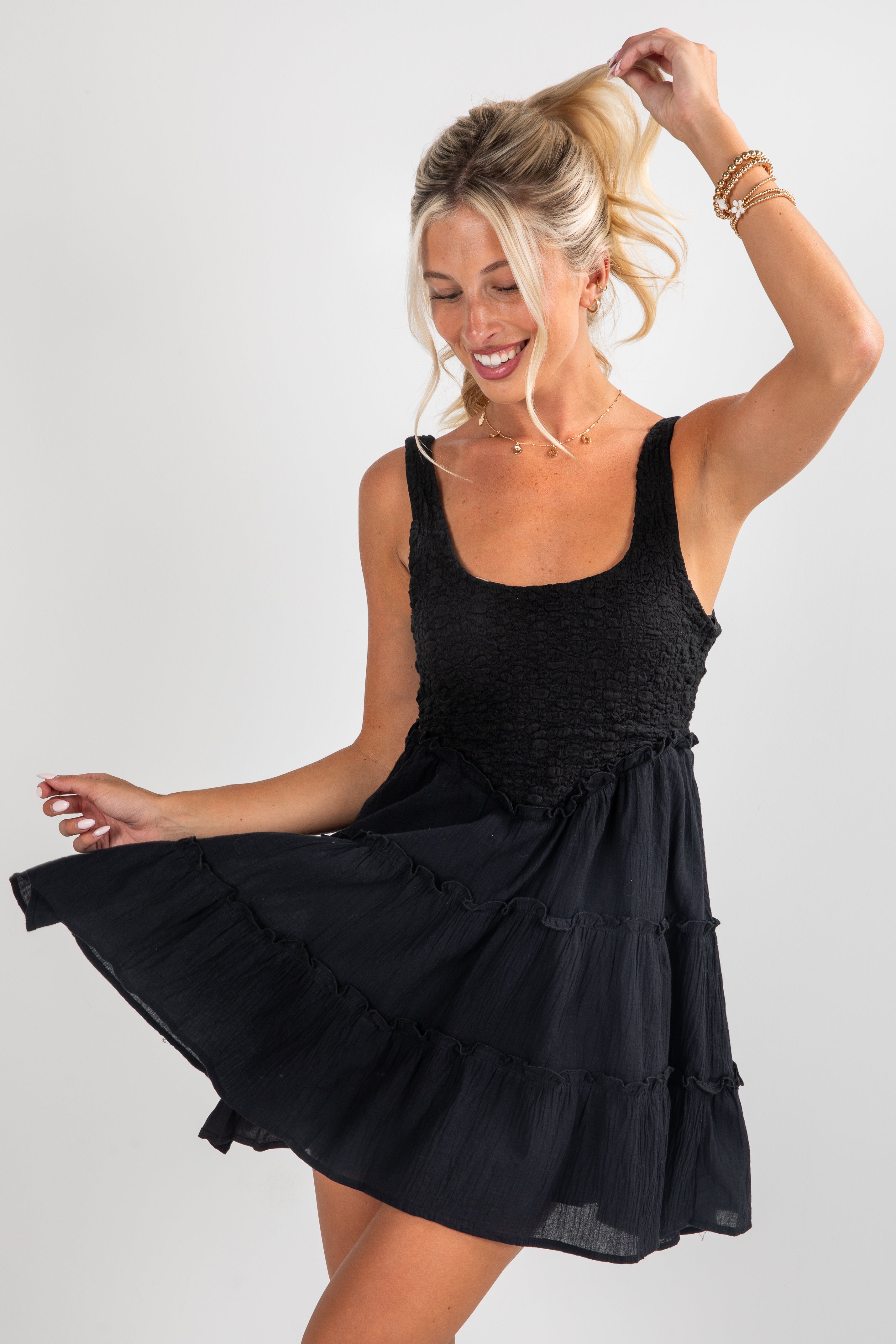 Woman wearing a black dress against a white background