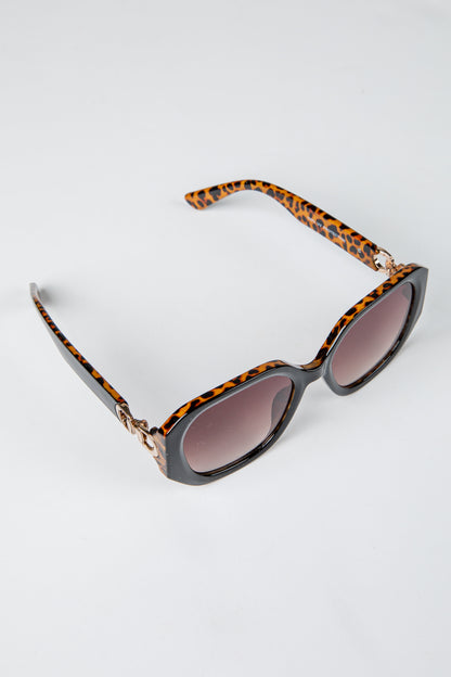 Sunglasses with tortoiseshell frame and brown lenses on a white background